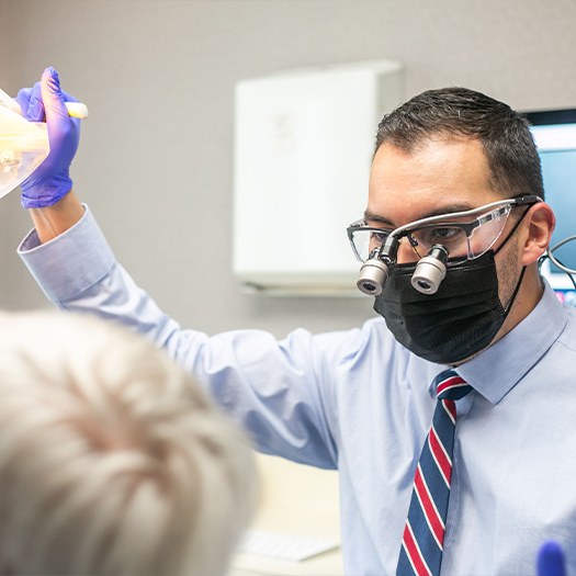 Dentist wearing a face mask and dental binoculars