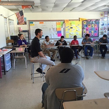 Doctor Duarte talking about dental health at local middle school