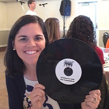 Doctor Lee holding a record that says Dianna Lee and the Temptations