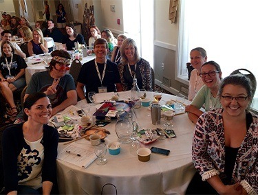Dentists and team members at Triple Crown Study Club table