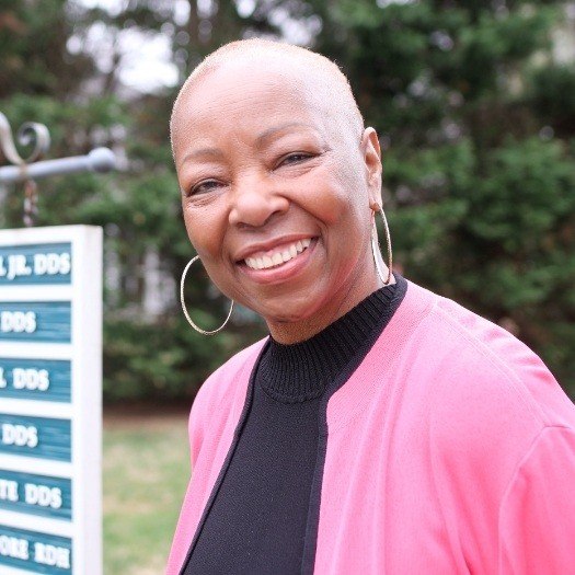 Smiling woman in pink cardigan