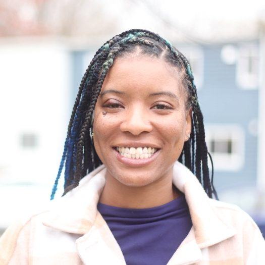 Woman in white jacket grinning