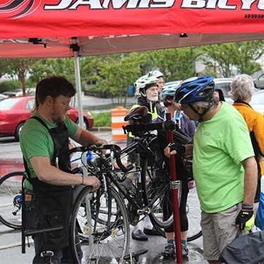 Two men checking bike during bike to work week