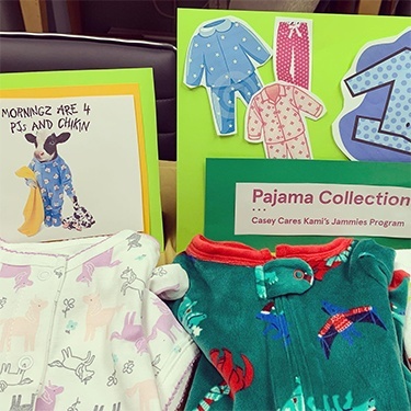 Folded pajamas for kids next to sign reading Pajama Collection