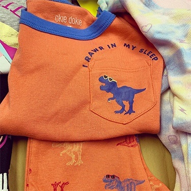 Orange pajama shirt with blue dinosaur