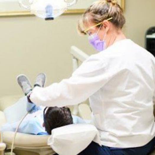 Dental team member treating a child patient