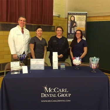 Four dental team members at indoor table