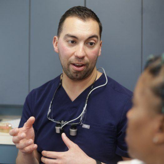 Doctor Duarte explaining something to a dental patient