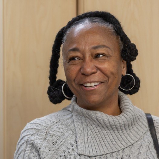 Woman in gray sweater smiling