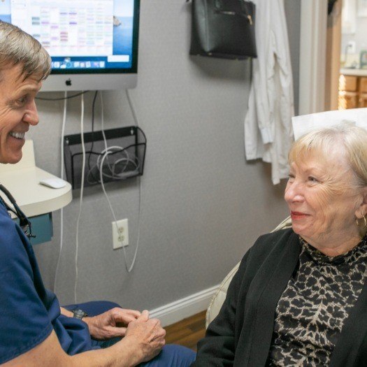 Senior woman smiling at her dentist