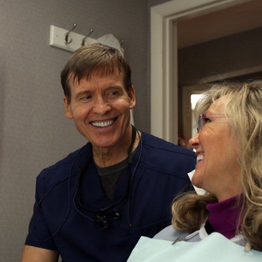 Doctor Clayton McCarl smiling at a dental patient