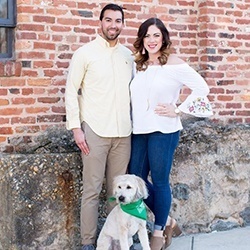 Doctor Duarte smiling with his wife and dog