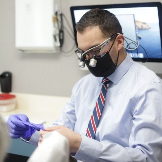 Doctor Duarte wearing dental binoculars