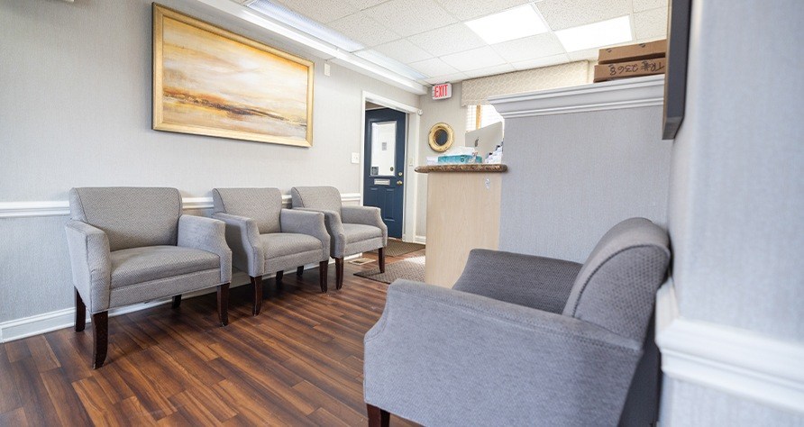 Gray armchairs in dental office reception area