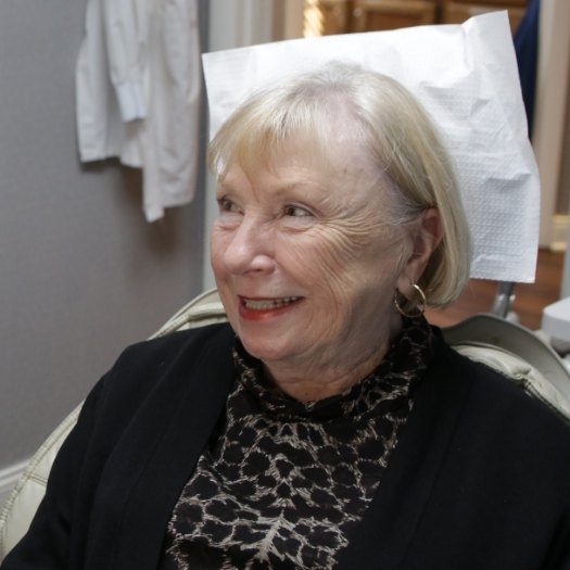 Smiling senior woman sitting in dental chair