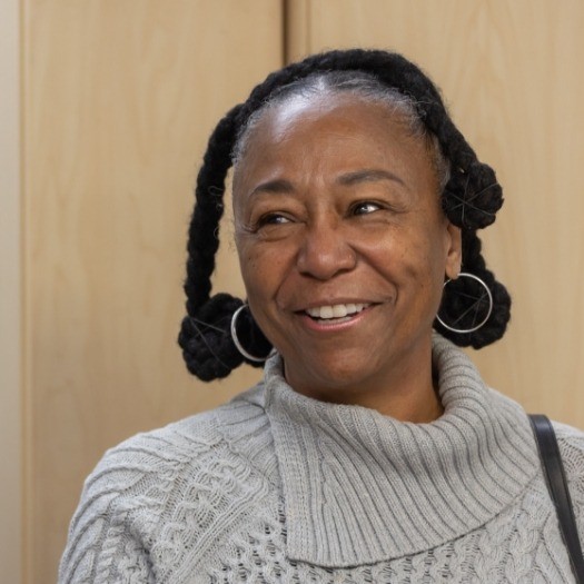 Woman in gray sweater smiling