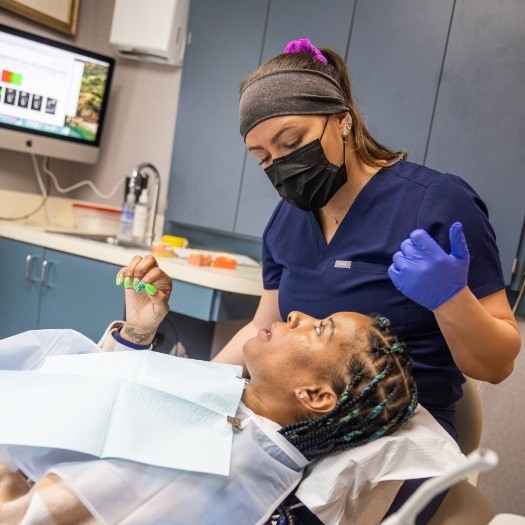 Dental team member talking to a patient