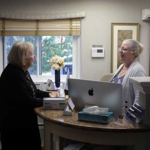 Dental patient talking to dental office receptionist