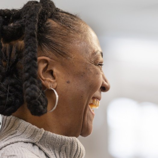 Woman in gray sweater grinning