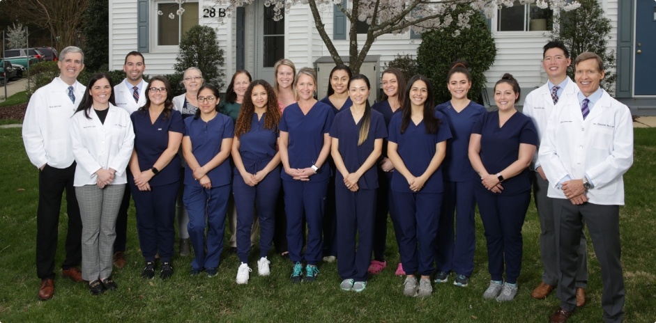 Smiling Greenbelt dentists and team members standing outside of McCarl Dental Group P C