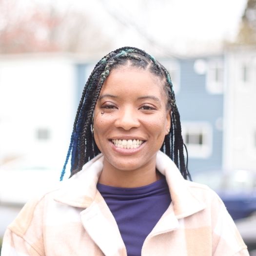 Woman smiling with straight teeth thanks to Invisalign