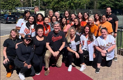 Dental team members wearing Orioles jerseys