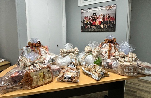 Several wrapped piles of Thanksgiving food on a table