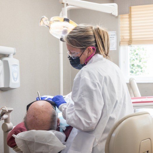 Woman flossing her teeth after tooth-colored filling treatment