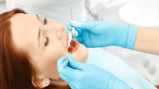 Cosmetic dentist examining a patients mouth