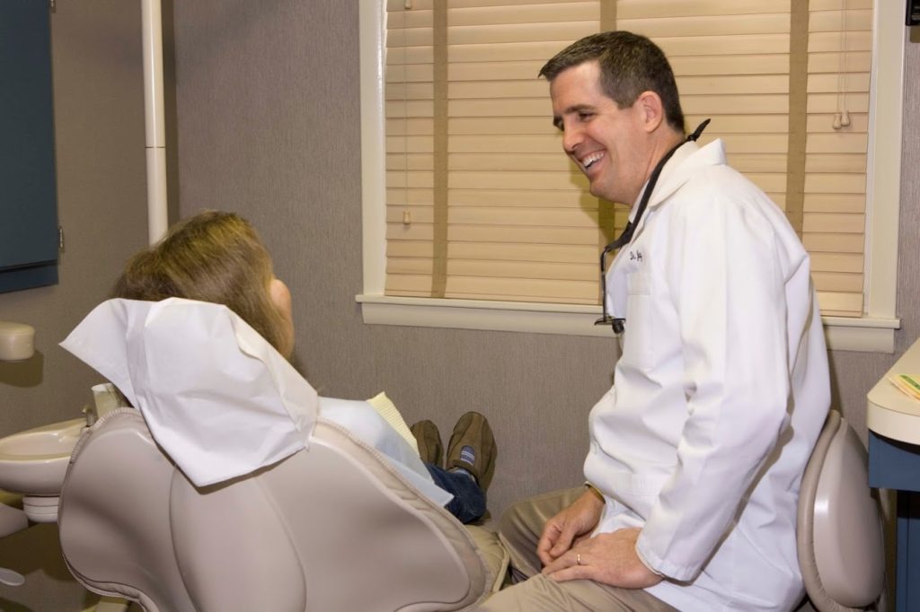 laughing dentist and relaxed patient