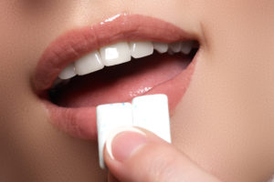 Woman chewing teeth whitening gum