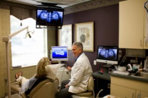 dentist and patient review dental x-rays