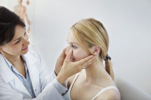 Dentist checking woman's facial shape