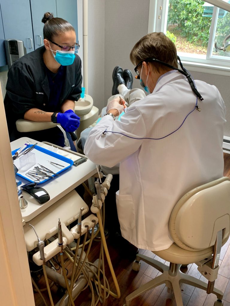 Dr. McCarl and dental assistant treating patient